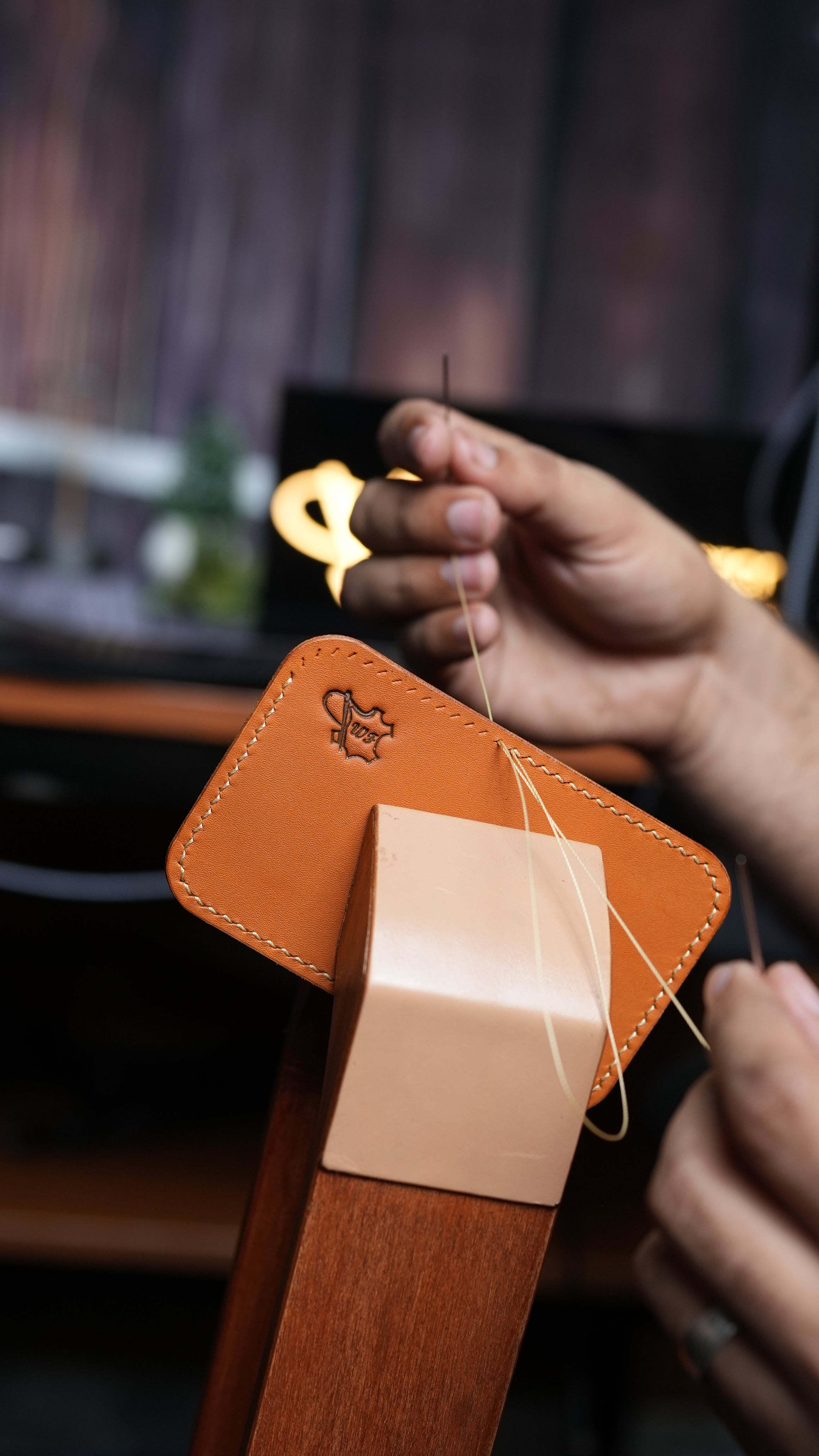 Personalized full-grain leather desk mat with embossed logo and stitched edges.