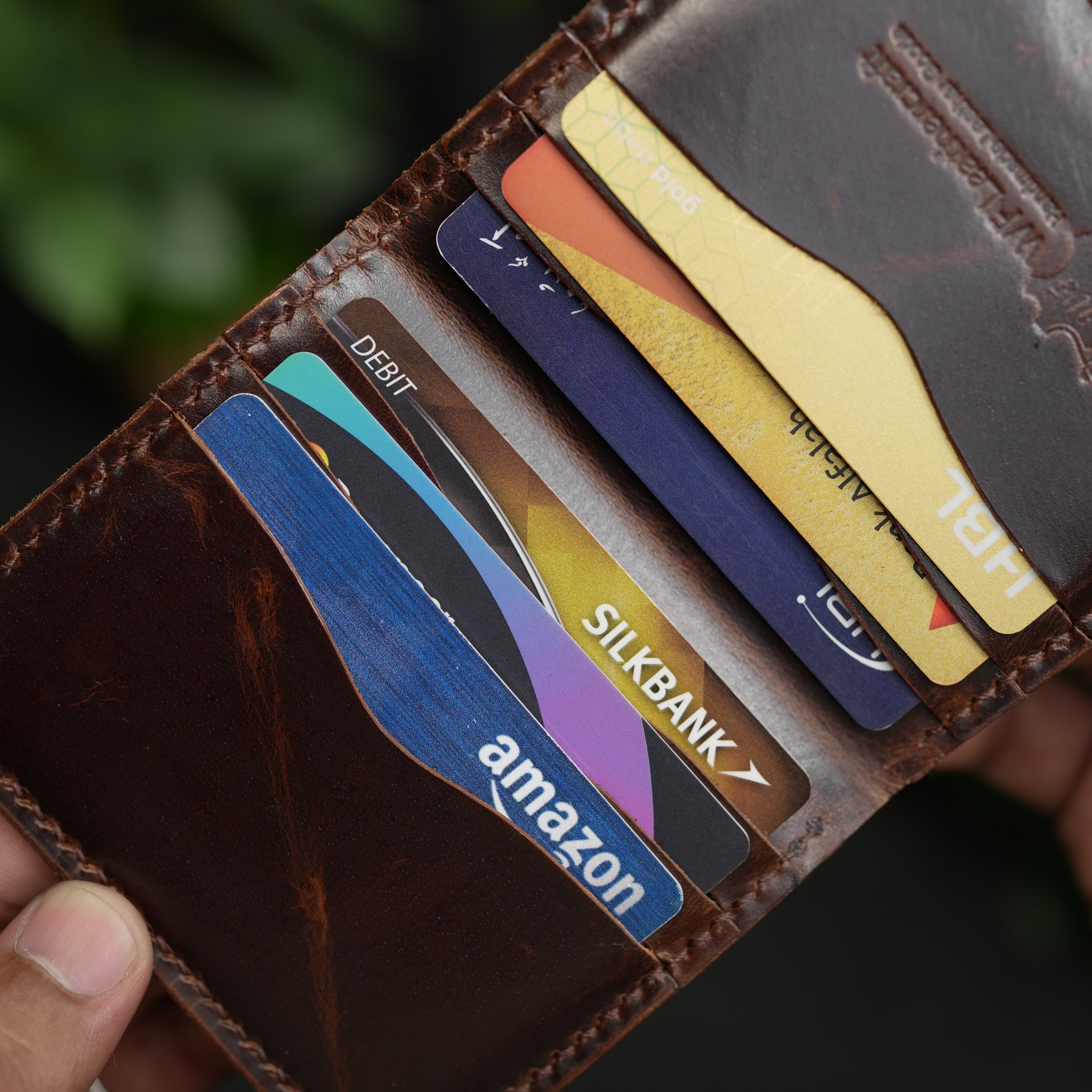Close-up of a wallet with various cards including Amazon and SilkBank.